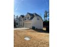 Two-story house with a two car garage and a large yard at 1276 Huntington Place Cir, Lithonia, GA 30058