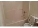 Simple bathroom with a shower-tub combo, toilet, and tiled floor at 2920 Vining Ridge Ter, Decatur, GA 30034