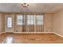 Spacious living room with hardwood floors, large windows, and elegant chandelier at 3479 Chestnut Dr, Atlanta, GA 30340