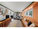 Cozy living room with leather couch, wooden entertainment center, and view of the kitchen at 770 Rochelle Sw Dr, Atlanta, GA 30310