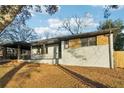 Exterior view of a renovated single-Gathering home with a white brick facade at 2385 Tilson Rd, Decatur, GA 30032