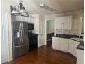 Kitchen with white cabinets, granite countertops, and stainless steel appliances at 7115 Shady Oak Ln, Cumming, GA 30040