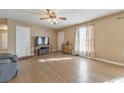 Bright living room with hardwood floors and a ceiling fan at 2413 Kennesaw Due West Nw Rd, Kennesaw, GA 30152