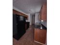 Galley kitchen with black appliances and ample counter space at 8095 Flamingo Dr, Jonesboro, GA 30238