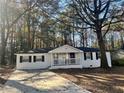 Charming white home with a covered front porch and driveway at 1543 California Ave, Conley, GA 30288