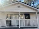 Inviting covered front porch with black front door and festive holiday decor at 1543 California Ave, Conley, GA 30288
