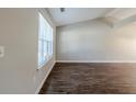 Living room with dark brown wood-look floors and a large window at 1275 To Lani Farm Rd, Stone Mountain, GA 30083