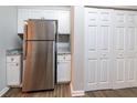 Updated kitchen features white shaker cabinets, stainless steel appliances, granite countertops, and pantry at 5136 Huxley Rd, Stone Mountain, GA 30088