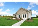 Back view of new construction home showing the backyard and concrete walkway at 443 Village Ln, Fairburn, GA 30213