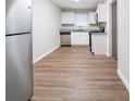 Updated kitchen featuring white cabinets, stainless steel appliances, and wood-look flooring at 2131 Meador Se Ave, Atlanta, GA 30315