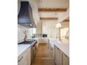 Bright, spacious kitchen with white cabinetry, large range, and farmhouse sink at 225 Maison Ct, Roswell, GA 30076