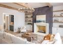 Inviting living room with fireplace, built-in shelves, and exposed beams at 225 Maison Ct, Roswell, GA 30076