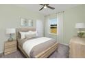 Cozy bedroom with wood bedframe, carpeted floors, and natural light at 398 Village Ln, Fairburn, GA 30213