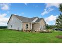 Side view of a new construction home with brick and siding exterior and a landscaped yard at 476 Village Ln, Fairburn, GA 30213