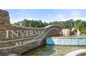 Inverness at Sugarloaf community entrance with stone monument and water feature at 979 Cades Walk, Lawrenceville, GA 30045