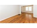 Empty living room with hardwood floors, neutral-toned walls, and multiple windows at 2454 Spring Garden Sw Dr, Atlanta, GA 30315