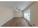Spacious living room with ample natural light, ceiling fan, and wood-look floors at 1852 Shamrock Dr, Decatur, GA 30032