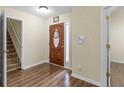 Inviting foyer with wood-look flooring, a staircase, and access to adjacent rooms at 221 Prominent Loop, Mcdonough, GA 30253