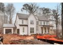 White two-story farmhouse with a gray metal roof and attached garage at 494 Michael Dr, Alpharetta, GA 30009