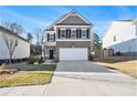 Two-story house with gray siding, brick accents, and a two-car garage at 9004 Jim Purcell Dr, Covington, GA 30014