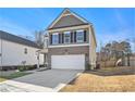 Two-story house with gray siding, brick accents, and a two-car garage at 9004 Jim Purcell Dr, Covington, GA 30014