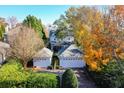 Backyard of a two story house with two car garage and fall foliage at 2111 Cooper Lake Se Rd, Smyrna, GA 30080