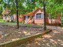 Brick home nestled among trees, featuring a front walkway and retaining wall at 318 Dogwood Trce, Mcdonough, GA 30252