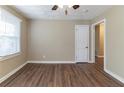 Spacious bedroom with wood-look flooring and ceiling fan at 1807 Oakmont Nw Dr, Atlanta, GA 30314