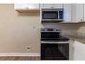 Modern kitchen with stainless steel appliances and granite countertops at 1807 Oakmont Nw Dr, Atlanta, GA 30314