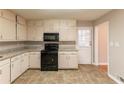 Galley kitchen with granite counters and black appliances at 3457 Springlake Dr, Decatur, GA 30032