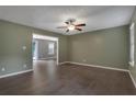 Spacious living room with hardwood floors, ceiling fan, and doorway leading to another living area at 4378 Ridge Ct, Loganville, GA 30052
