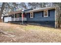 Gray sided ranch home with white trim, red door and a covered porch at 155 Meadowbrook Dr, Mcdonough, GA 30253