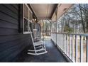 Relaxing front porch with two white rocking chairs at 155 Meadowbrook Dr, Mcdonough, GA 30253