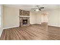 Living room features a stone fireplace and wood-look flooring at 2329 Wilkins Cv, Decatur, GA 30035