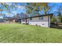 Side view of a ranch home with white brick and a grassy yard at 1933 Glen Echo Dr, Decatur, GA 30032