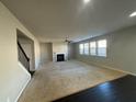 Spacious living room with fireplace, carpet, and ceiling fan at 566 Mariposa Ln, Mcdonough, GA 30253