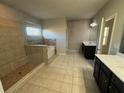 Large main bathroom featuring a separate tub, walk-in shower, and dual vanity at 566 Mariposa Ln, Mcdonough, GA 30253