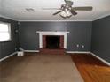 Spacious living room with brick fireplace, hardwood floors, and carpet at 10155 Twin Oaks Sw Dr, Covington, GA 30014