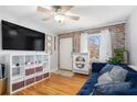 Living room with hardwood floors, a blue couch, and a large TV at 24 Daniel Se St # 8, Atlanta, GA 30312