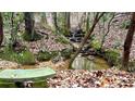 Small creek running through wooded area with a bench for relaxing at 7460 Highway 101 N, Rockmart, GA 30153