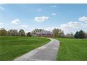 Long driveway leading to a red brick home with green lawn and trees at 2984 Berry Rd, Loganville, GA 30052