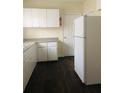 Bright kitchen with white cabinets, dark floors, and a white refrigerator at 309 Fletcher Sw St, Atlanta, GA 30315