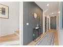 Inviting hallway with dark accent wall, wood floors, and a stylish runner at 105 Channing Ln, Fayetteville, GA 30214