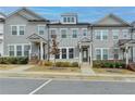 Attractive townhome exterior with gray siding, white trim, and a welcoming walkway at 2689 Richmond Row, Suwanee, GA 30024
