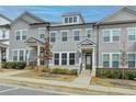 Beautiful townhome with gray siding, white trim, and landscaping details at 2689 Richmond Row, Suwanee, GA 30024