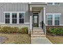 Close-up of the inviting front entryway with a green door and brick steps at 2689 Richmond Row, Suwanee, GA 30024