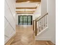 Bright foyer with wood floors, white geometric wall details, and wood staircase at 6214 Talmadge Nw Way, Acworth, GA 30101