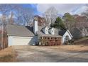 Light blue home with white garage doors, gray roof, and landscaping at 3075 Heather Stone Way, Lawrenceville, GA 30043