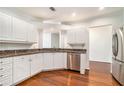 Modern kitchen featuring stainless steel appliances, white cabinetry, and granite countertops at 3334 Peachtree Ne Rd # 908, Atlanta, GA 30326