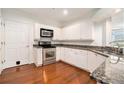 Bright kitchen with white cabinets, stainless steel appliances, and granite countertops at 3334 Peachtree Ne Rd # 908, Atlanta, GA 30326